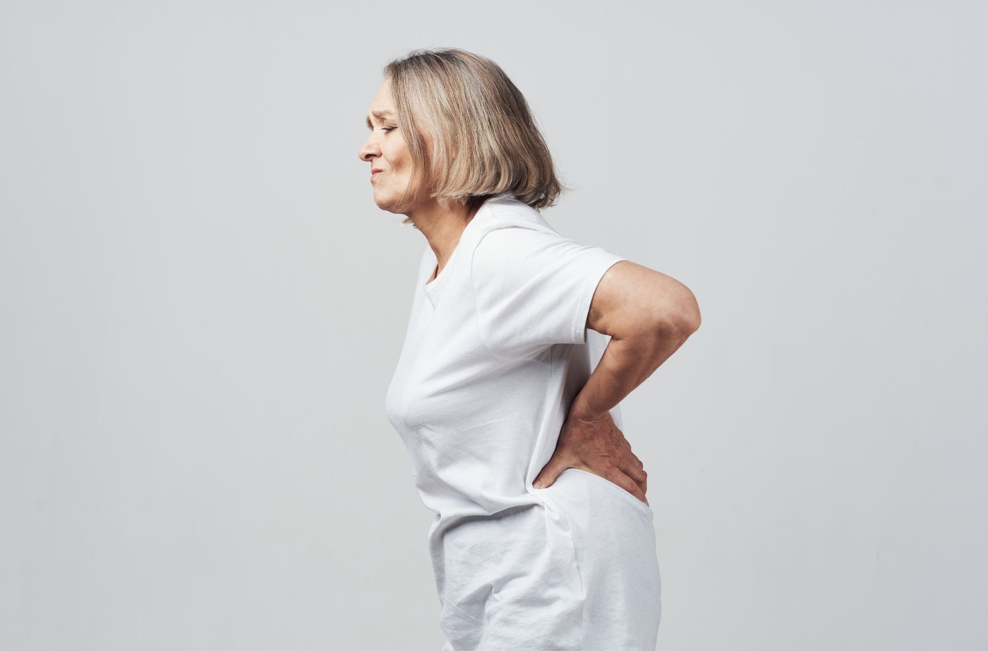 A woman suffering from lower back pain.